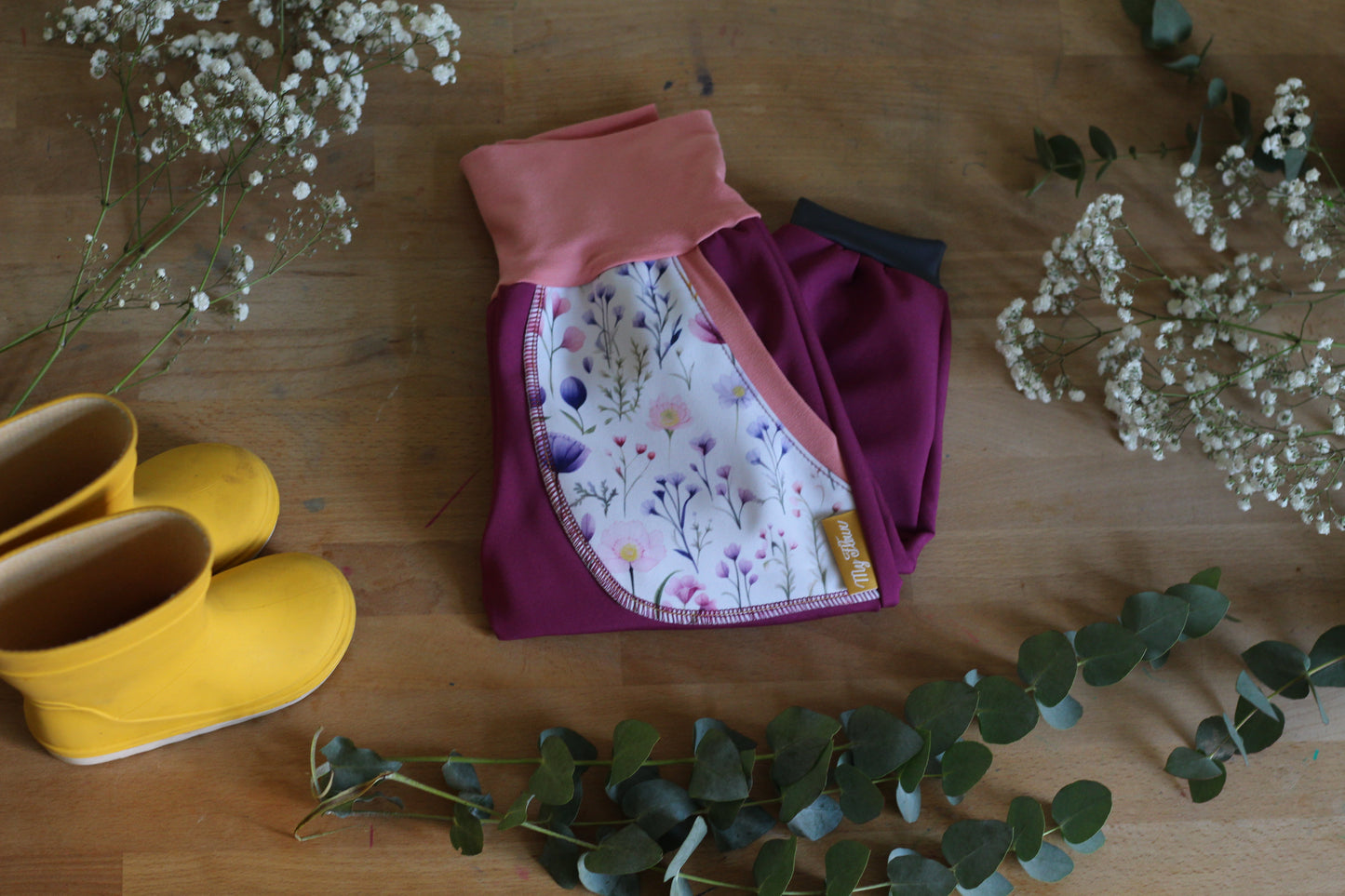 Purple softshell trousers, white flowers